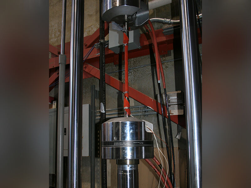 Industrial work area. Megalex™ sucker vertically extended between large metallic fixtures.  
